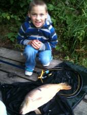 This is Ben Hendy, aged 7, on only his 2nd-ever fishing trip with a lovely 9lb mirror carp from the Match Lake caught on sweetcorn. 
