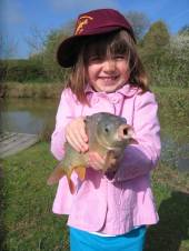 This is Emily, aged 4 (sister of Lucy - see photo below) with her first fish.  Super photo!