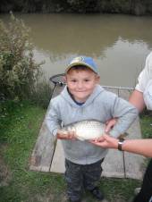 Jack Glew aged 6yrs with a common carp weighing 2 1/2lb caught on bread flake floated on top.
