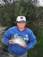 Mark Glew aged 13yrs with a common carp weighing 2lb again caught on bread flake floated on top.