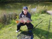 This is Jason Gore with a lovely 11lb common carp from Rushcombe Lake.  This fish made up part of his record-breaking pleasure bag - details on the Rushcombe lake page.