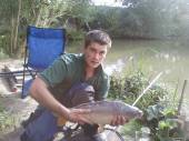 This is Sam Hutchings with a lovey mirror carp from the Match Lake.